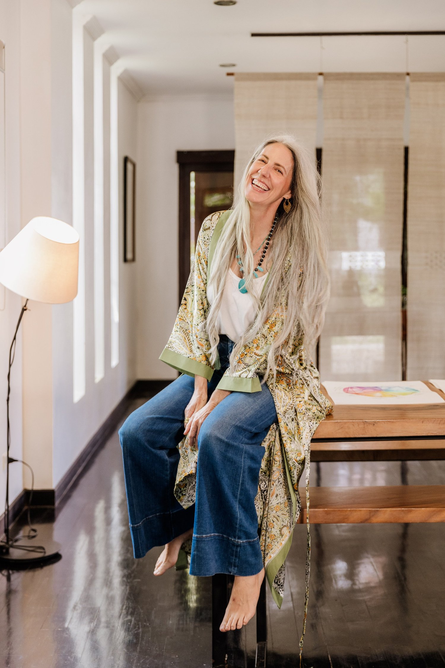 Helen Fehr smiling, seated in her workspace with natural light